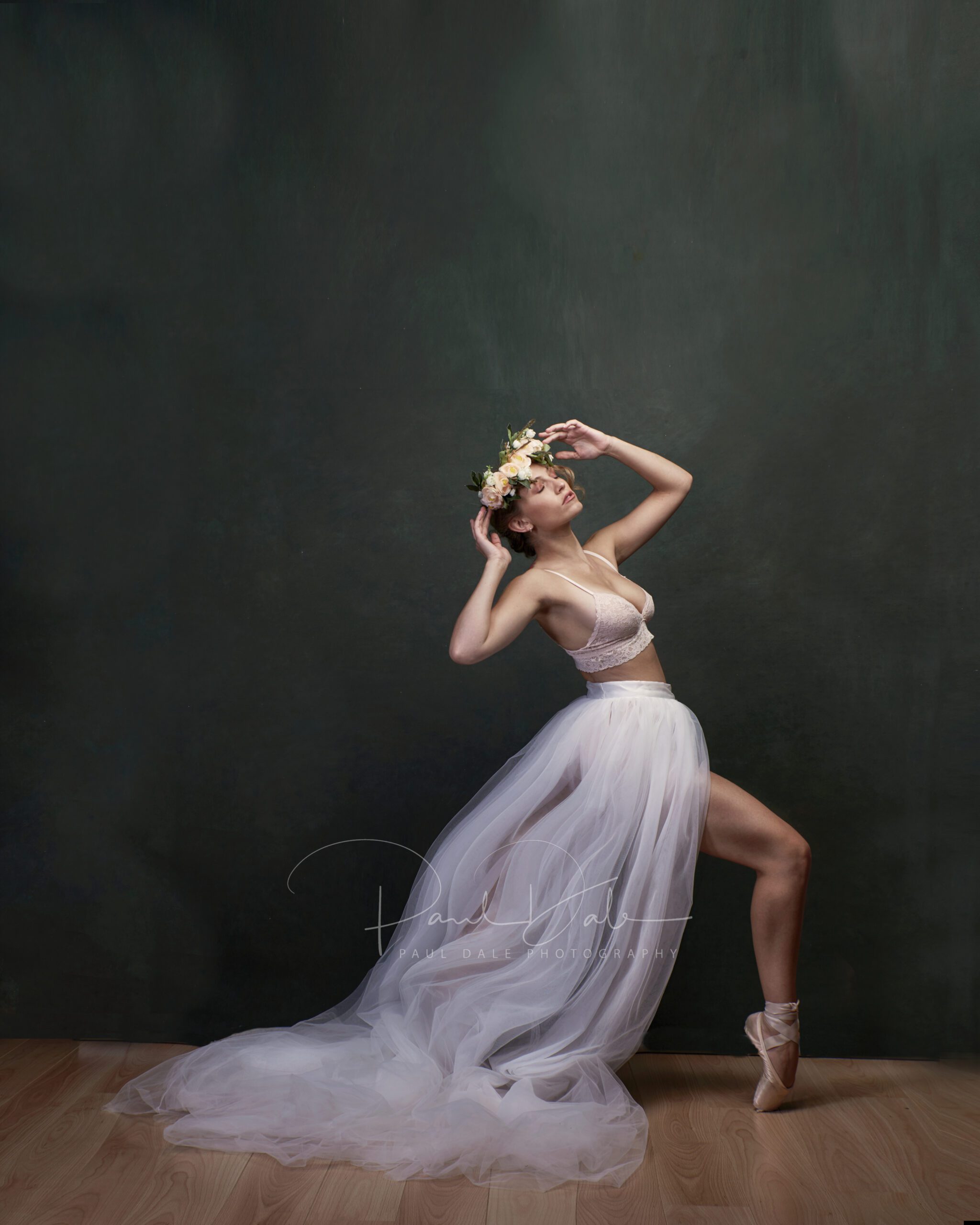 Ballet dancer in pointe shoes with a long flowing white skirt