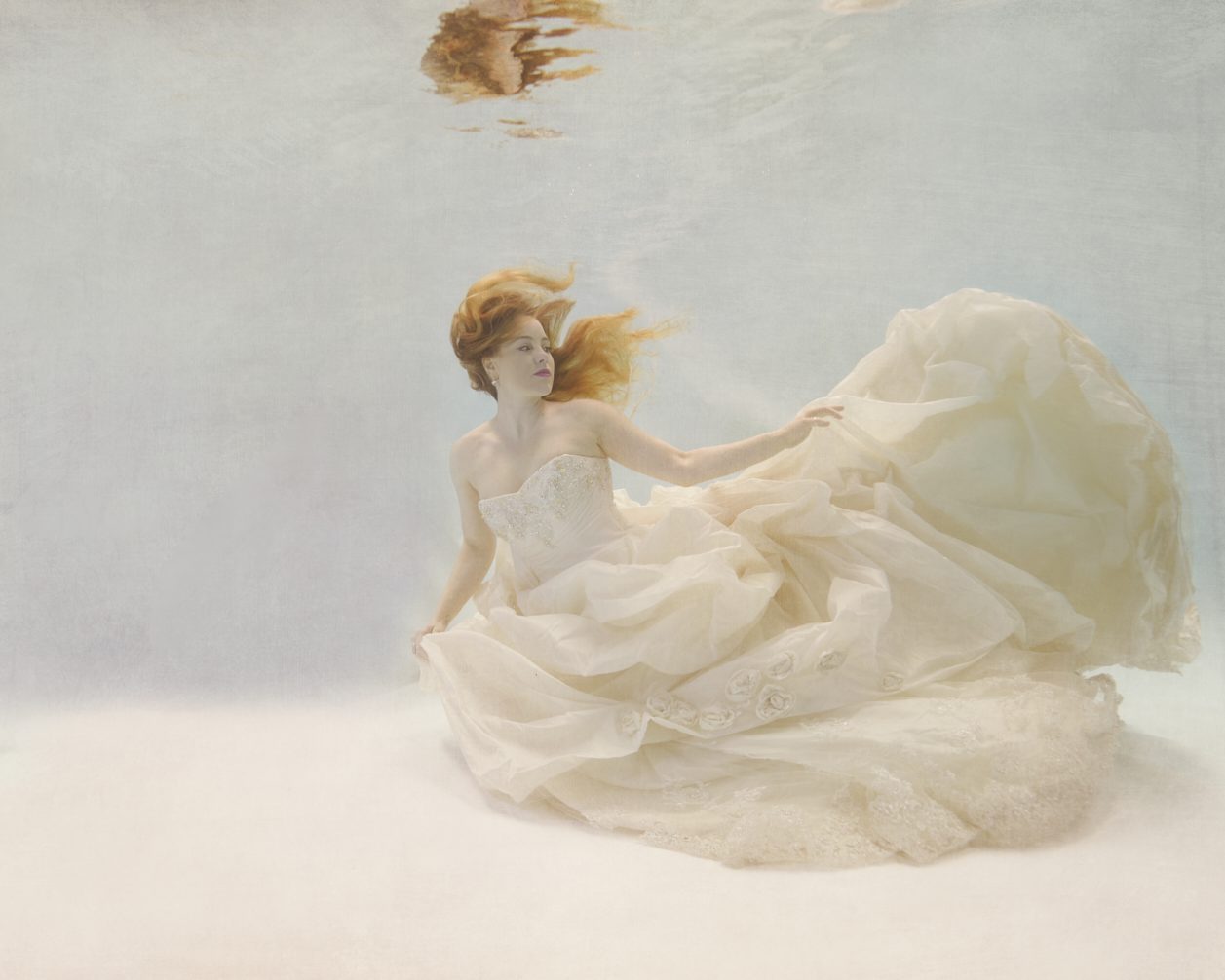 Beautiful model underwater Photoshoot in a cream wedding dress in Camberley (Surrey)