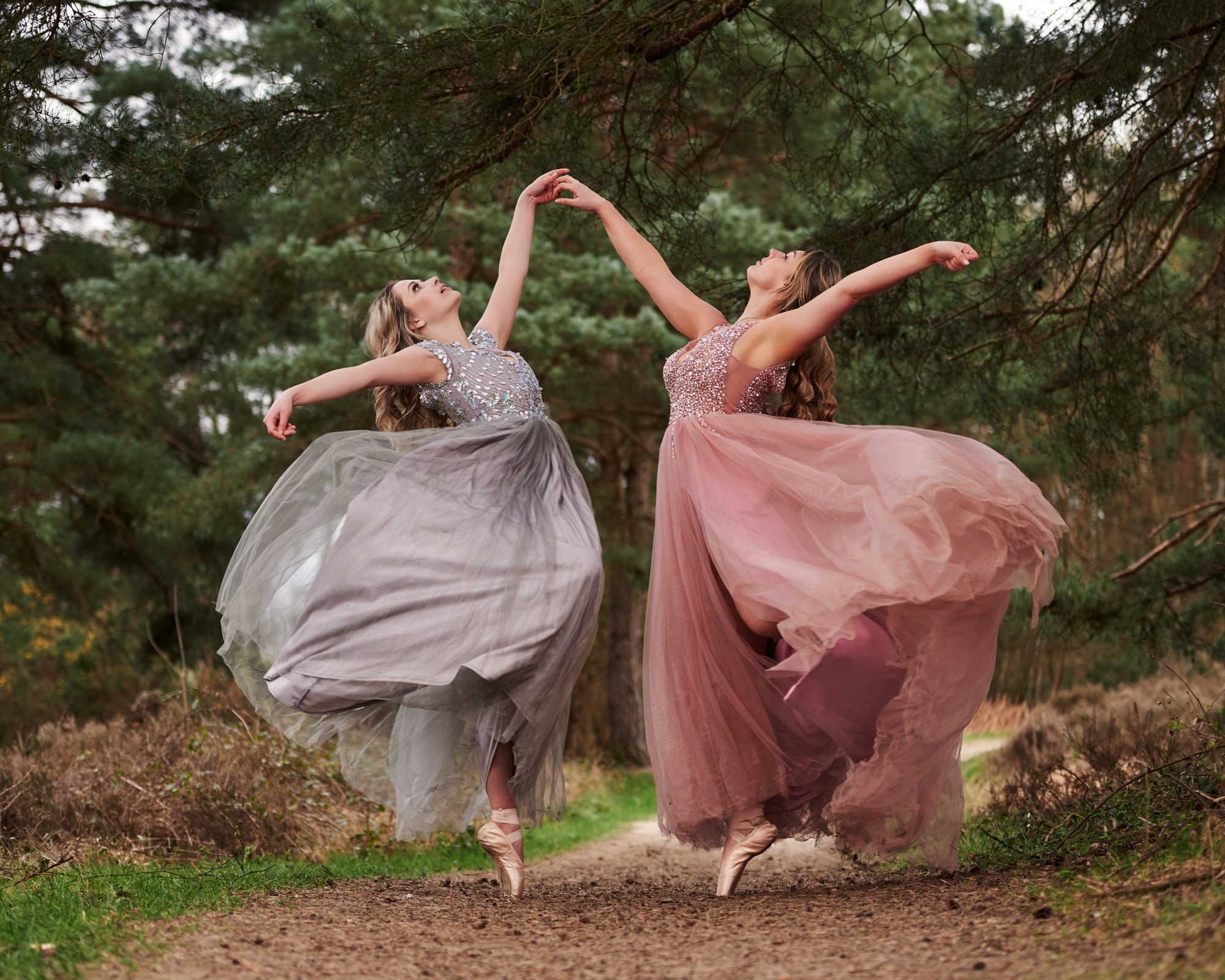 Two dancers posing in the woods